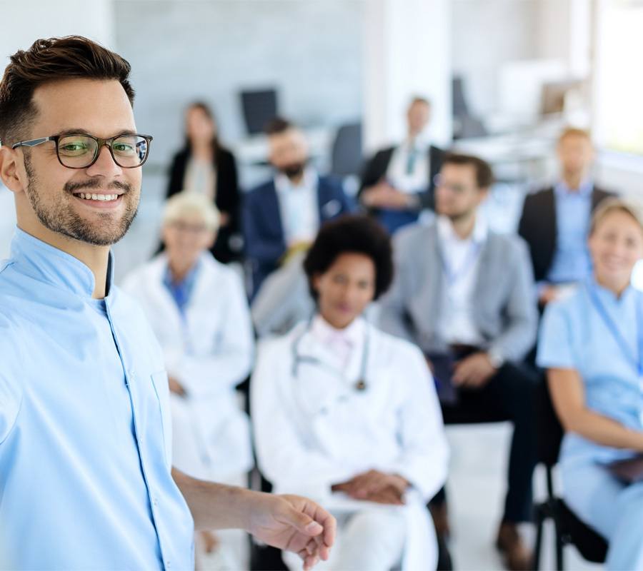 Happy businessman giving a presentation to group of colleagues a