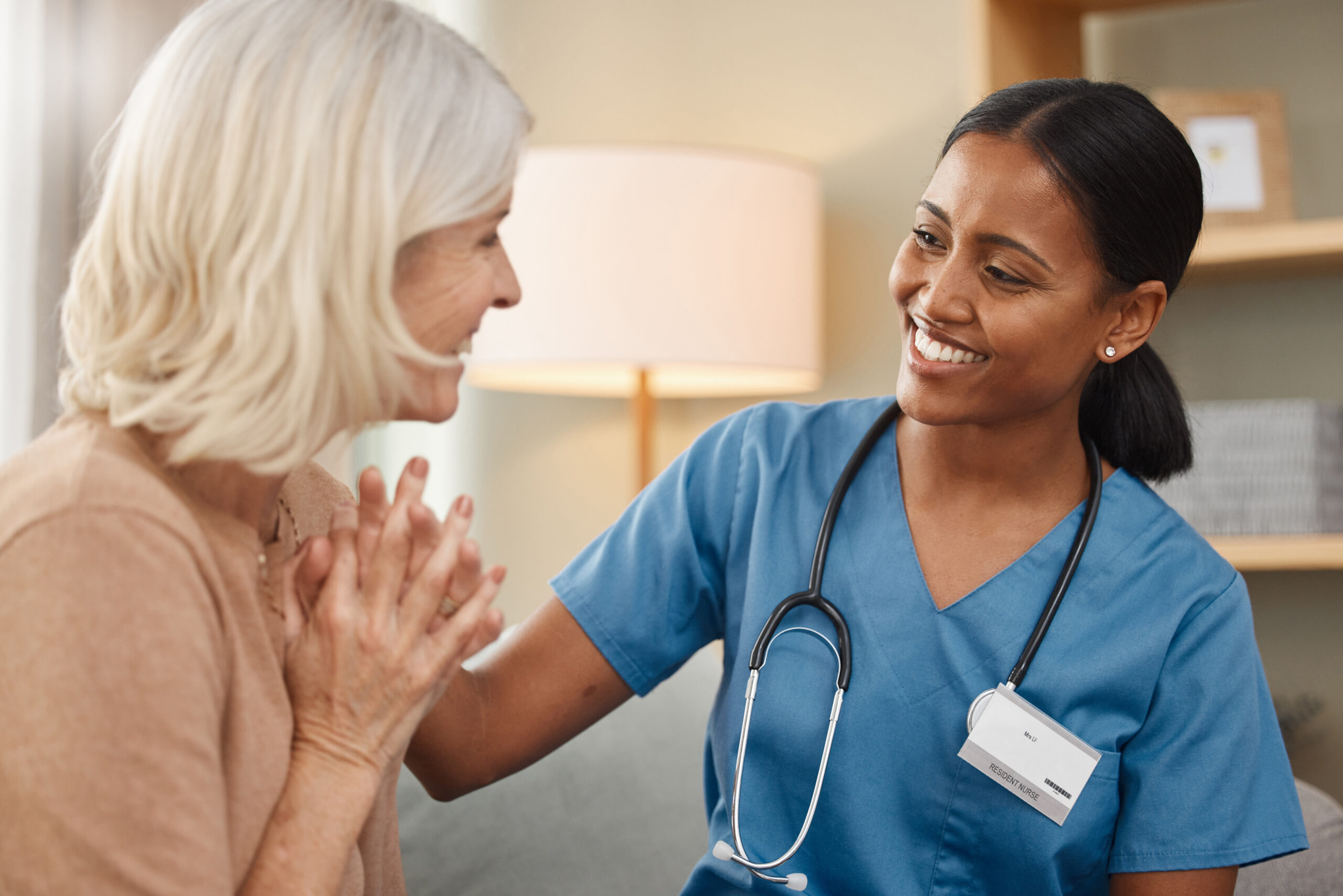 happy-healthcare-medical-with-old-woman-nurse-sofa-retirement-home-together-assisted-living-conversation-smile-with-senior-patient-talking-medicine-professional-apartment
